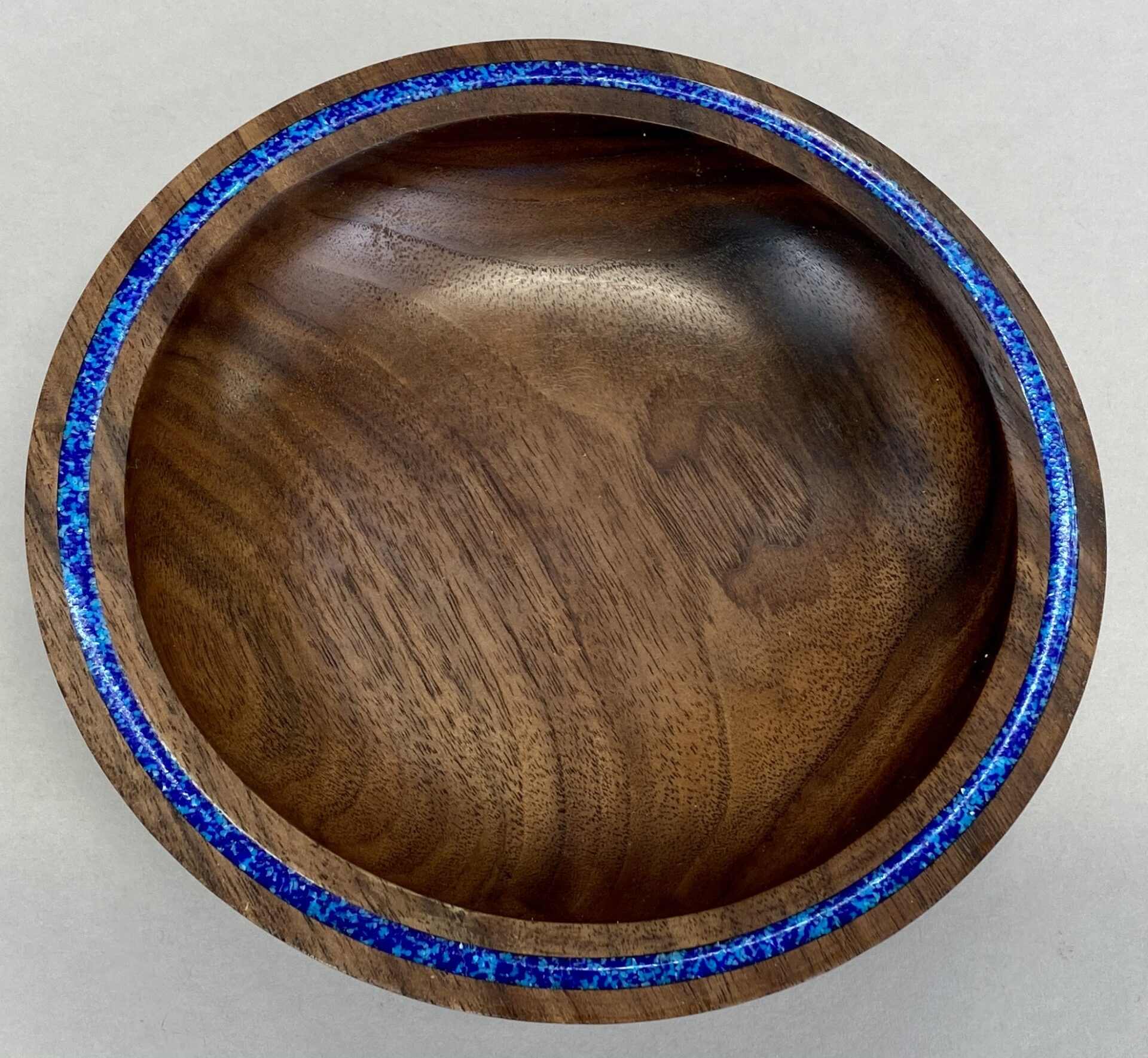a wooden bowl with the blue strip by AB Woodworking