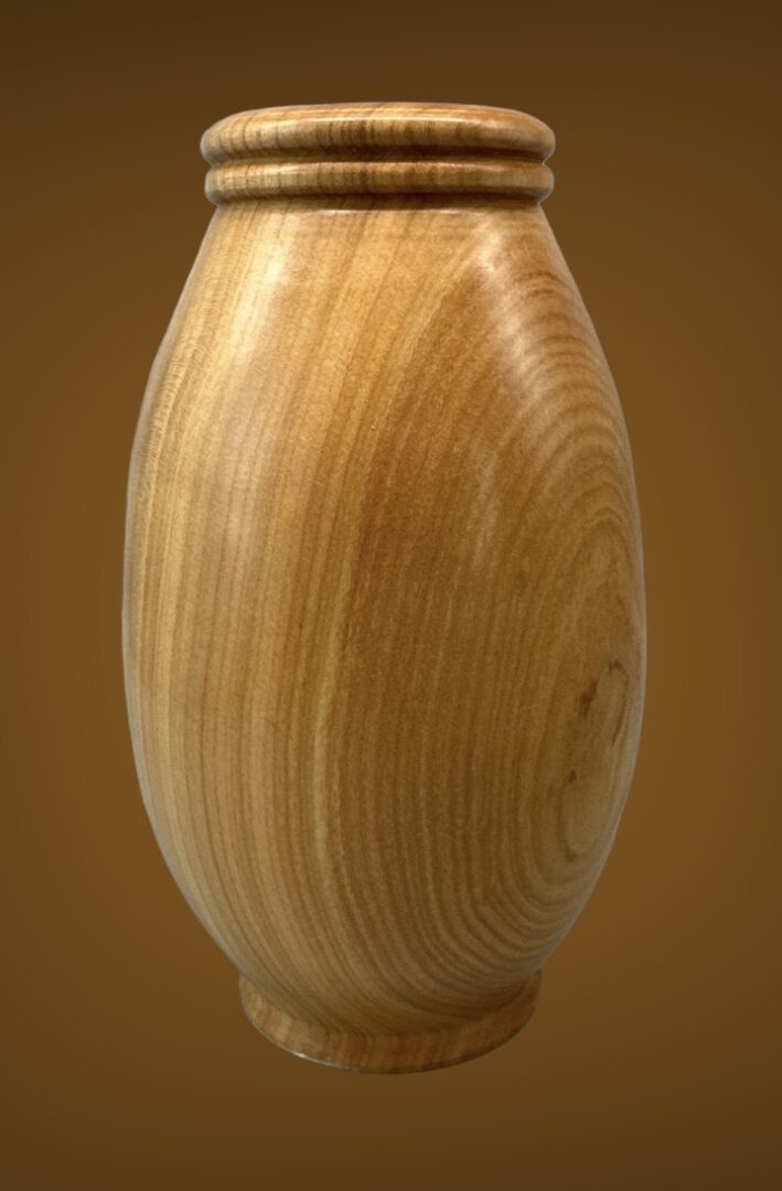 A wooden vase with a brown background