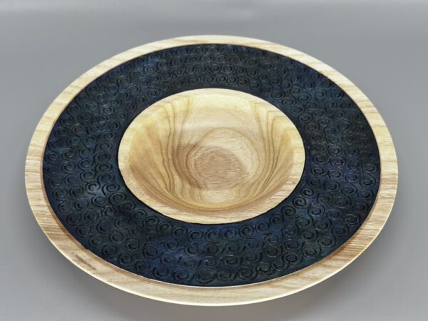 A bowl and plate with black design on it.